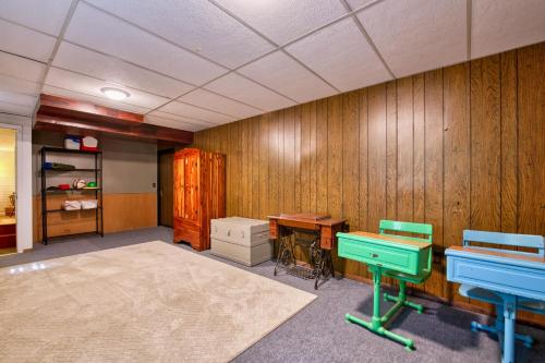 a room with wooden walls and a desk and a table at Nature's Edge in Asheville