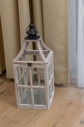 a glass lantern with a black top on a floor at Pobierowo Beach Baltic Apartment with Pool by Noclegi Renters in Pobierowo