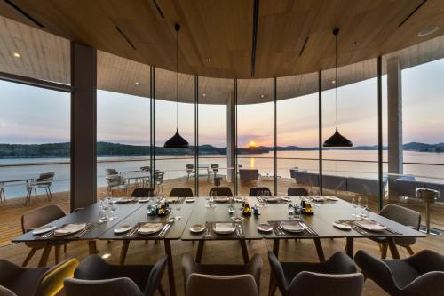 a dining room with a large table and chairs at D-Resort Šibenik in Šibenik