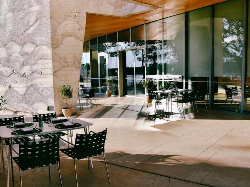 a restaurant with tables and chairs in front of a building at D-Resort Šibenik in Šibenik