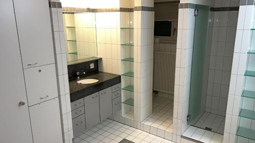 a bathroom with a sink and a mirror at Ferienwohnung Rütiboda 8-10 Personen in Davos