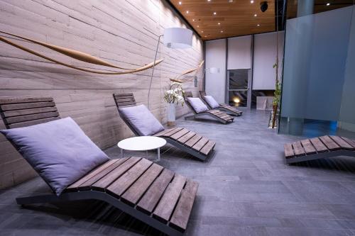 a lobby with benches and a table and a fireplace at D-Resort Šibenik in Šibenik