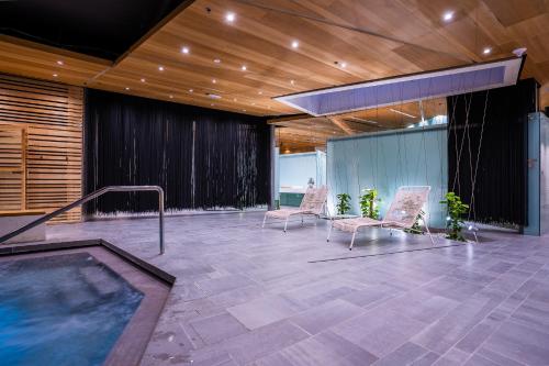 a hot tub in a room with chairs and a ceiling at D-Resort Šibenik in Šibenik