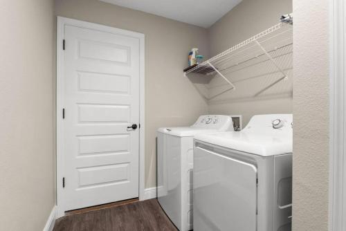 a white laundry room with a washer and dryer at Pet-friendly, Heated Pool, Close to Everything 3 Bedroom Home in Dunnellon