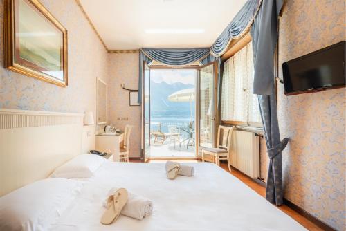 Postel nebo postele na pokoji v ubytování Hotel Le Palme