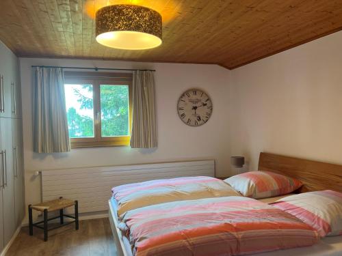 a bedroom with two beds and a clock on the wall at Voa Crestas 7 (715 He) in Sporz