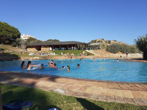 a group of people in a swimming pool at Cozy summer house in Alvor