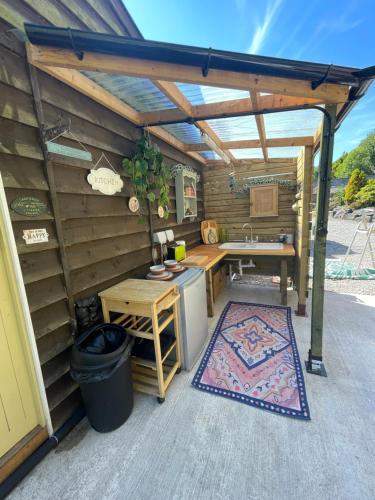 a patio with a sink and a table in a shed at Thistlebank Yurt in Llangollen