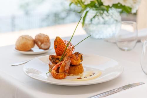 a white plate of food on a white table at Gran Talaso Hotel Sanxenxo in Sanxenxo