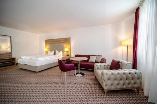 a hotel room with a bed and a couch at EE Hotel in Kassel