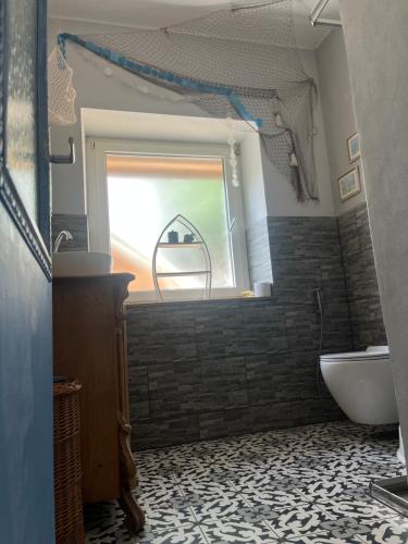 a bathroom with a window and a tub and a sink at Haus Bell in Trippstadt