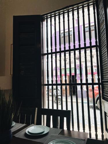 a table with a view of a building through a window at 3-BR in the heart of the Historical City in San Juan