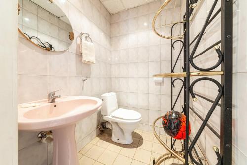 a bathroom with a sink and a toilet and a mirror at Old villa Kaprice Baltic Beach in Jūrmala