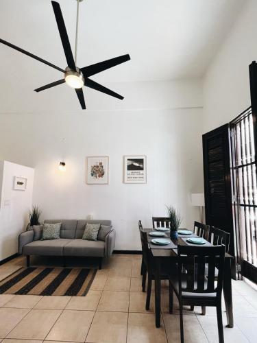 a living room with a couch and a ceiling fan at 3-BR in the heart of the Historical City in San Juan
