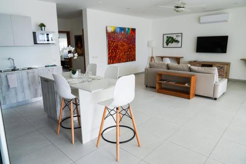 a kitchen and living room with a table and chairs at Stella Aparthotel, Las Terrenas in Las Terrenas