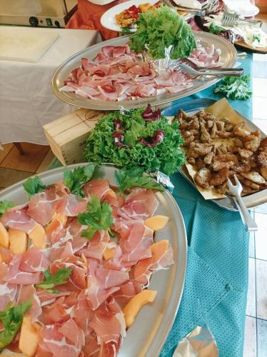 a table with three plates of food on it at IHR Hotel Villa Emma in Canazei