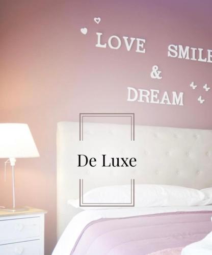 a bedroom with a bed with love and dream decals at B&B incentro in Foggia