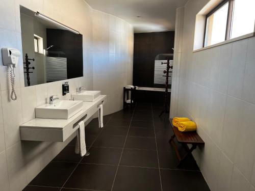 a bathroom with two sinks and a large mirror at Foz Club - Algarve in Alvor