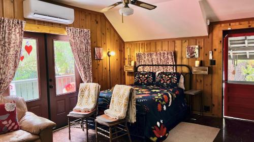 a bedroom with a bed and two chairs at Peaceful Cabin in Idyllwild