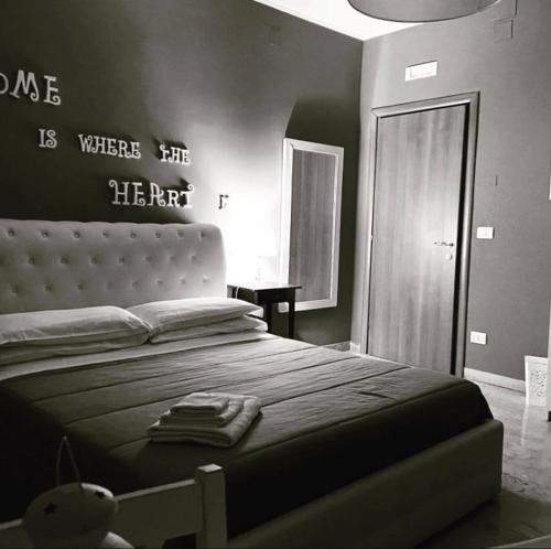 a bedroom with a bed with a sign on the wall at B&B incentro in Foggia