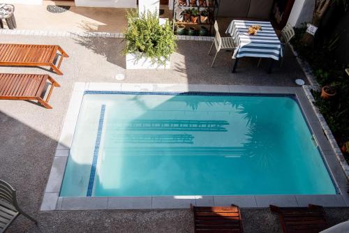 an overhead view of a swimming pool with a table and chairs at Paternoster Dunes Boutique Guesthouse in Paternoster