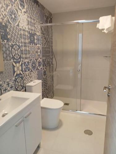 a bathroom with a shower and a toilet and a sink at Pension Xacobeo Lavacolla in Lavacolla