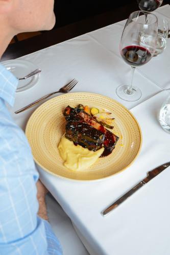 a plate of food on a table with a glass of wine at DiplomaticHotel in Mendoza