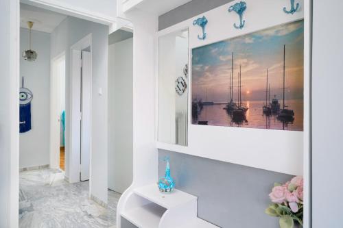 a white hallway with a painting on the wall at yiayia and papou Luxury House in Limenas