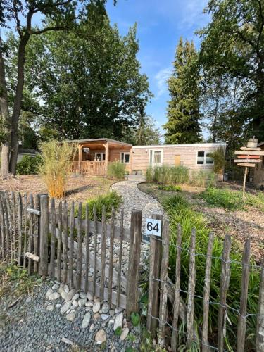 a wooden fence in front of a house at Trendy House Hattem nr64 in Hattemerbroek