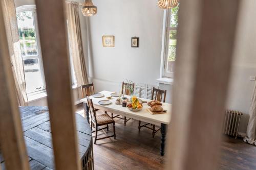 a dining room with a table with food on it at Boddington Mill, Enchanting 3 Bdr Retreat by Oriri in Cheltenham