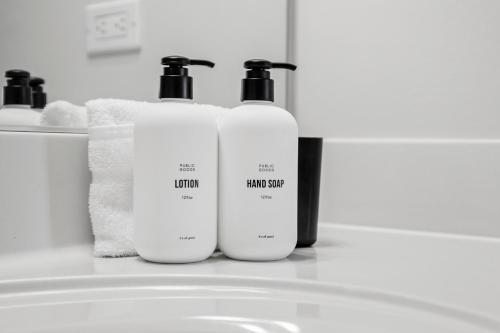 a group of three bottles of laundry detergent on a bathroom counter at Placemakr Premier SoBro in Nashville