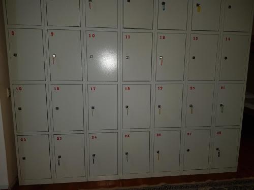 a wall of lockers with red numbers on them at Hostel 888 in Almaty