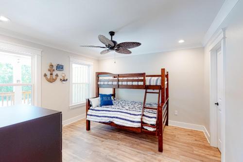 a bedroom with a bunk bed and a ceiling fan at Beach Cottage East in Dauphin Island