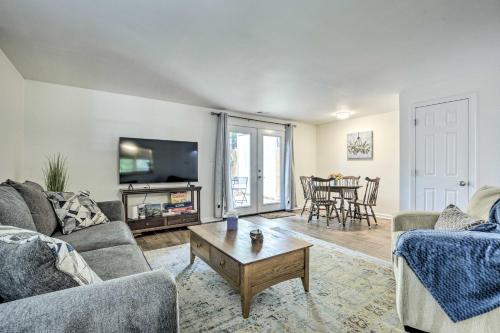 a living room with two couches and a table at Walk to Dtwn and Breweries Townhome in Cary! in Cary