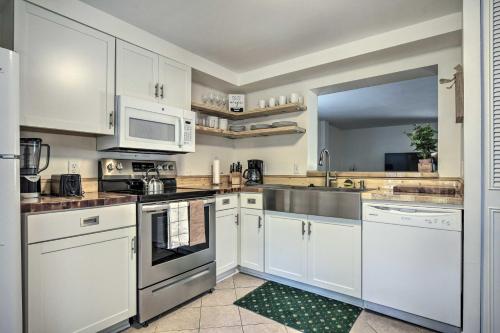 a kitchen with white cabinets and a sink at Walk to Dtwn and Breweries Townhome in Cary! in Cary