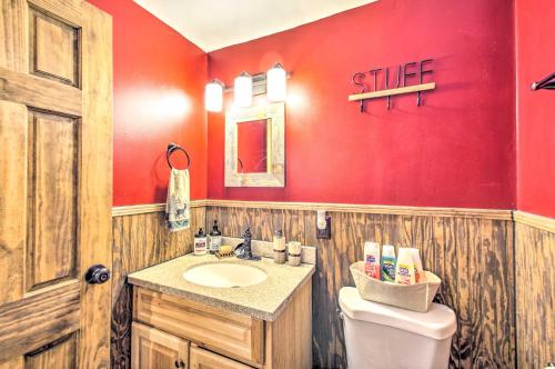 a bathroom with a sink and a red wall at The Dodge Lodge Steps to Massanutten Adventures! in McGaheysville