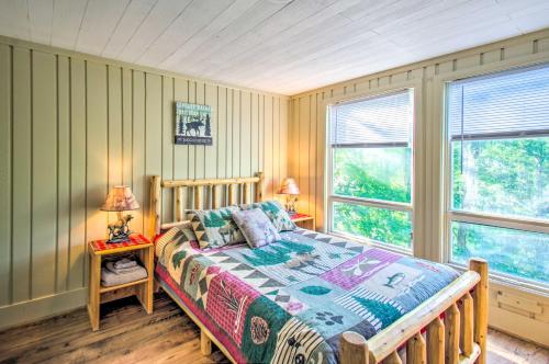 a bedroom with a bed and two windows at The Dodge Lodge Steps to Massanutten Adventures! in McGaheysville