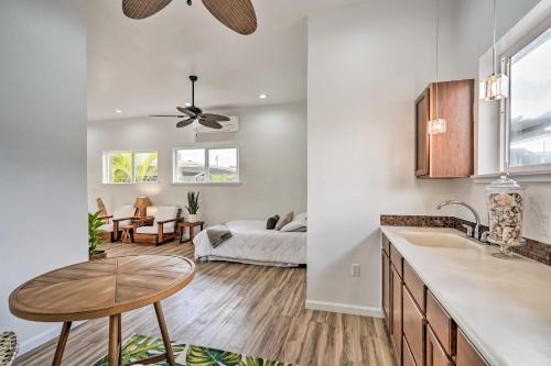 a kitchen and living room with a table and a couch at Sunny Kailua Home with Covered Lanai 1 Mi to Beach! in Kailua