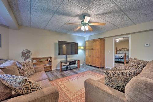 a living room with two couches and a flat screen tv at Lakefront Getaway with Private Dock and Kayaks! in Bella Vista
