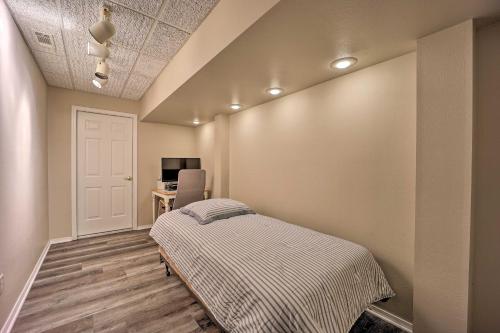 a bedroom with a bed and a desk at Lakefront Getaway with Private Dock and Kayaks! in Bella Vista