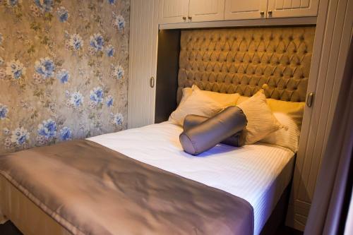a large bed with a large headboard and pillows at HOPE SAPANCA in Sakarya