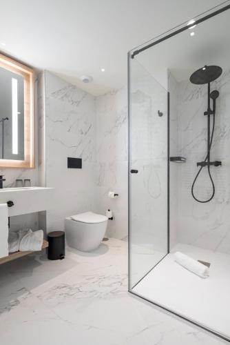 a bathroom with a glass shower and a toilet at Attica21 Vigo 4 Superior in Vigo