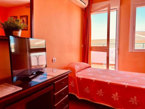 Posteľ alebo postele v izbe v ubytovaní Hostal Muriel