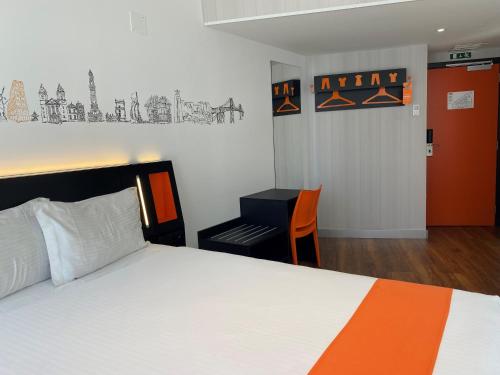 a bedroom with a bed and a desk in it at easyHotel Lisbon in Lisbon