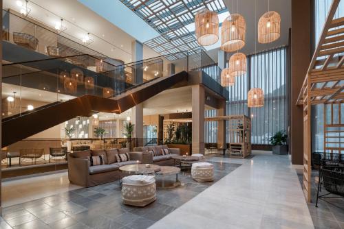 a lobby with couches and a staircase in a building at Attica21 Vigo 4 Superior in Vigo