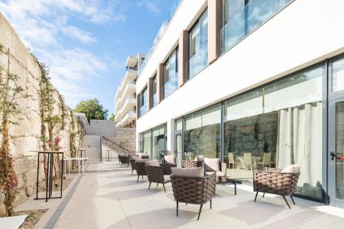 an outdoor patio with chairs and a building at Attica21 Vigo 4 Superior in Vigo