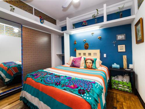 a bedroom with a bed with a man on it at Casa Itzae B&B Polanquito Dog Friendly in Mexico City