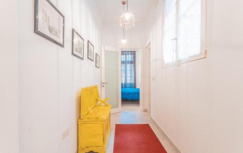a hallway with a yellow dresser and a red rug at Blue Waves Apartment with Maltese Balcony in Valletta