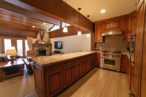 a kitchen with wooden cabinets and a stove top oven at Flagstaff Two Bedroom apartment hotel in Park City