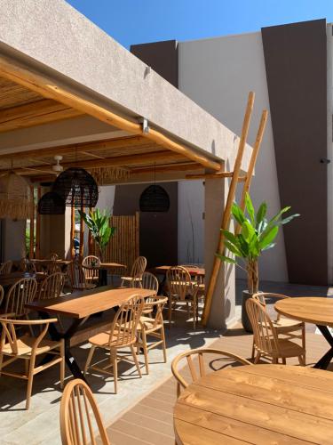 a restaurant with wooden tables and chairs at Del Mare Suites in Glífa